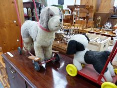 TWO VINTAGE PUSH ALONG DOG TOYS.