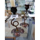 A PAIR OF ARTS AND CRAFTS COPPER CANDLESTICKS.