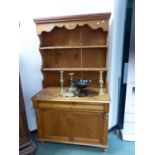 A PINE DRESSER WITH ENCLOSED BACK. W 107 x D 53 x H 191cms.