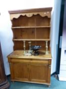 A PINE DRESSER WITH ENCLOSED BACK. W 107 x D 53 x H 191cms.