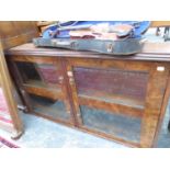 A GLAZED BURR WALNUT BOOK SHELF. W 113 x D 27 x H 66cms.