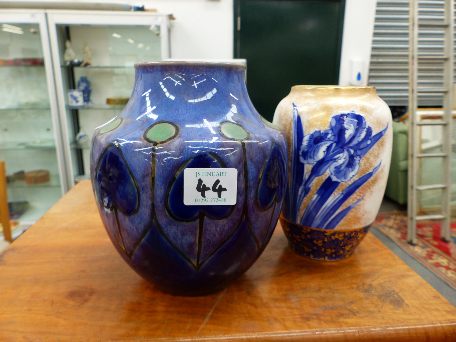 A ROYAL DOULTON ART NOUVEAU POTTERY VASE, AND A LATER VASE DECORATED WITH IRISES.