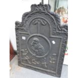 AN ANTIQUE CAST IRON FIRE BACK.