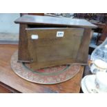 A SMALL OAK WALL CABINET AND A BRASS ENGRAVED TRAY.