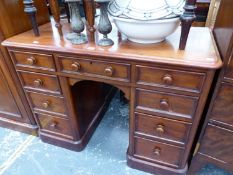 A MAHOGANY DESK, THE NINE DRAWERS WITH KNOB HANDLES