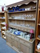 A MODERN PINE KITCHEN DRESSER AND PLATE RACK. W 152.5 X D 43 X H 204CMS.