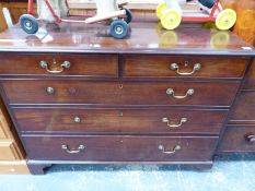 A LATE GEORGIAN MAHOGANY CHEST OF TWO SHORT AND THREE LONG DRAWERS ON BRACKET FEET, WITH BRASS