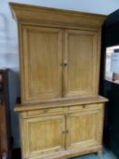 A PINE LINEN PRESS WITH CUPBOARDS ABOVE AND BELOW TWO CENTRAL DRAWERS. W 137 x D 54 x H 225cms.