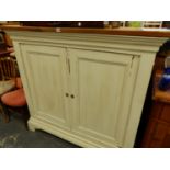 AN ANTIQUE AND LATER PAINTED PINE SIDE CABINET WITH TWO PANELLED DOORS. W 140 X D 61 X H 130CMS.