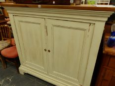 AN ANTIQUE AND LATER PAINTED PINE SIDE CABINET WITH TWO PANELLED DOORS. W 140 X D 61 X H 130CMS.