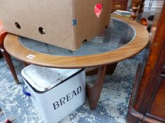 A GLASS TOPPED TEAK COFFEE TABLE TOGETHER WITH AN ORANGE UPHOLSTERED CHAIR