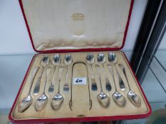 A CASED SET OF HALLMARKED SILVER TEASPOONS AND SUGAR TONGS.