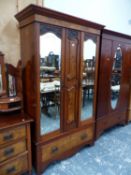 A MAHOGANY WARDROBE WITH TWO MIRRORED DOORS FLANKING TWO BURR WALNUT PANELS ABOVE A BURR WALNUT