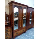 A MAHOGANY WARDROBE WITH TWO MIRRORED DOORS FLANKING TWO BURR WALNUT PANELS ABOVE A BURR WALNUT