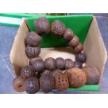 A ROW OF 25 AFRICAN CLAY DECORATED BEADS. LARGEST DIAMETER APPROX 3cms.
