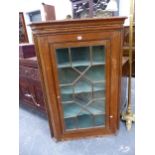 AN ASTRAGAL GLAZED OAK CORNER CUPBOARD WITH PAINTED SHELVES