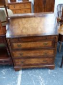 A BURR WALNUT BUREAU WITH BRUSHING SLIDE ABOVE THREE DRAWERS