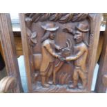 AN OAK CHAIR THE BACK CARVED WITH TWO MEN AND A GOAT TOGETHER WITH A RUSH SEATED OAK STOOL