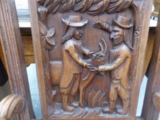 AN OAK CHAIR THE BACK CARVED WITH TWO MEN AND A GOAT TOGETHER WITH A RUSH SEATED OAK STOOL