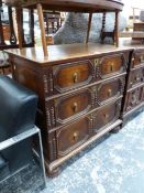 AN OAK CHEST OF THREE GRADED LONG DRAWERS APPLIED WITH CENTRAL AND FLANKING PAIRS OF SPINDLES TO THE