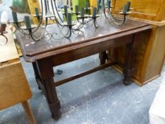 AN OAK TABLE WITH SUBSTANTIAL CYLINDRICAL LEGS