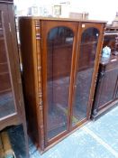 A MAHOGANY DISPLAY CABINET WITH GLAZED DOORS OVER ADJUSTABLE SHELVES