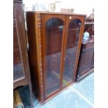 A MAHOGANY DISPLAY CABINET WITH GLAZED DOORS OVER ADJUSTABLE SHELVES