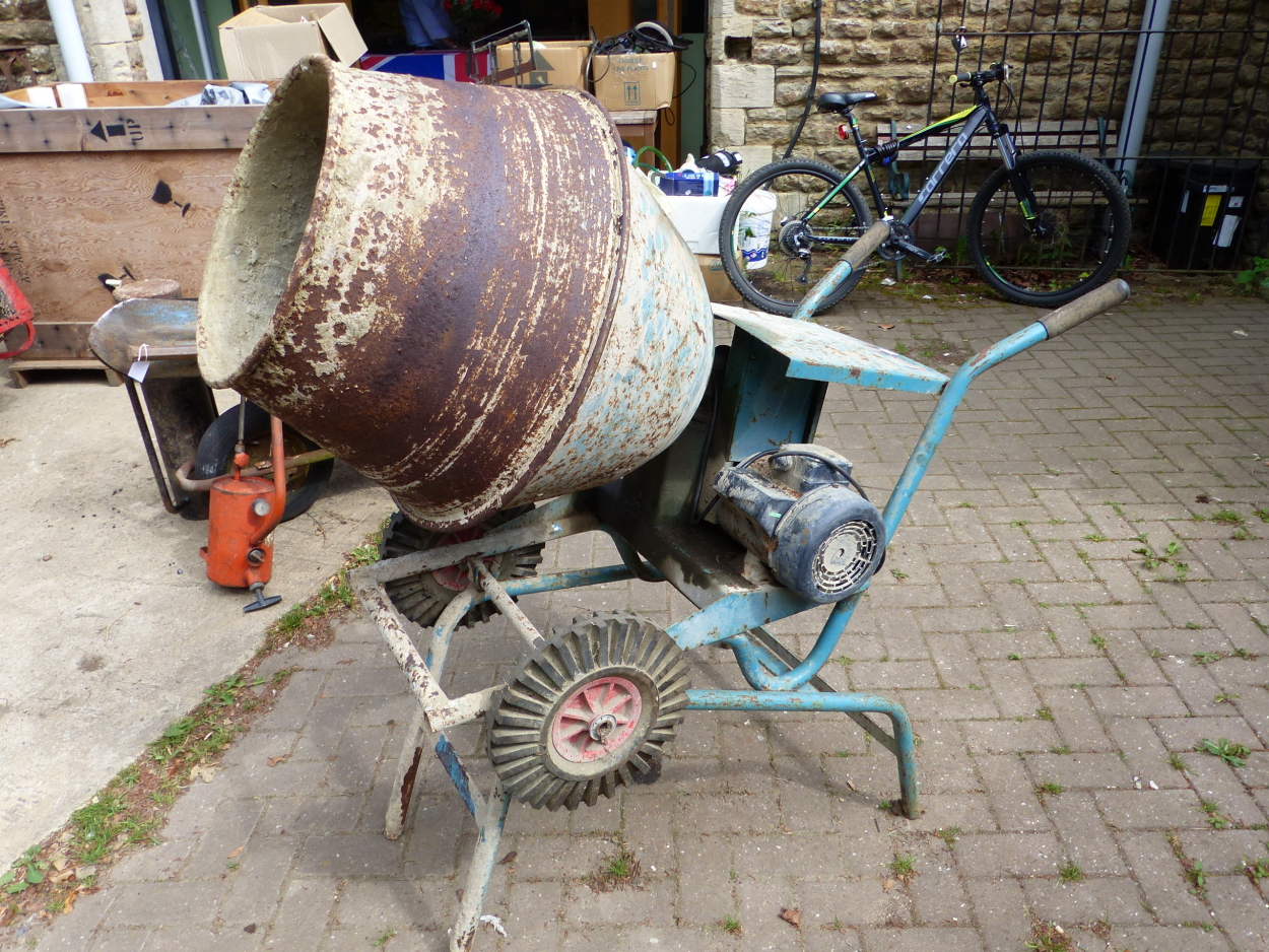 AN ELECTRIC CONCRETE MIXER COMPLETE WITH TRANSFORMER AND ANGLE CUTTER