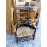 AN OAK RUSH SEATED ELBOW CHAIR ON CUT DOWN LEGS