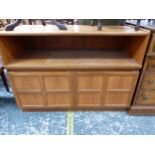 AN OAK SIDE CABINET WITH A SHELF OVER DOORS, EACH WITH FOUR PANELS