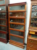 A BAND INLAID MAHOGANY GLOBE WERNICKE SIX SHELF CABINET WITH BASAL DRAWER