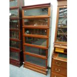 A BAND INLAID MAHOGANY GLOBE WERNICKE SIX SHELF CABINET WITH BASAL DRAWER