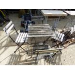 A WROUGHT IRON GARDEN TABLE AND FOUR CHAIRS