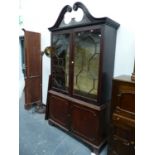AN 18th C. MAHOGANY DISPLAY CABINET, THE SWAN NECK TOP ABOVE ASTRAGAL GLAZED AND PANELLED DOORS ON