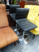 A PAIR OF BLACK LEATHERETTE AND CHROME ADJUSTABLE BAR STOOLS