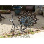A WROUGHT IRON WIND VANE AND TWO PLANT STANDS