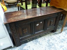 AN OAK THREE PANEL FRONTED COFFER INLAID WITH TWO CHEQUER SHIELDS