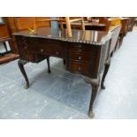 A MAHOGANY FIVE DRAWER TABLE, THE GADROONED EDGE TOP ABOVE LEATHER INSET WRITING SLIDE AND A