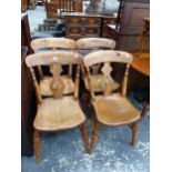 A SET OF FOUR OAK CHAIRS WITH PIERCED BALUSTER SPLATS ABOVE SADDLE SEATS
