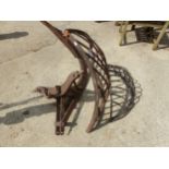 TWO CAST IRON HAY MANGERS AND LARGE PLOUGH ATTACHMENTS
