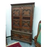 A 17th C. STYLE OAK WARDROBE WITH HANGING SPACE ABOVE TWO SHORT AND A LONG DRAWER