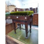 AN EDWARDIAN STAINED WOOD AND GREEN VELVET PIANO STOOL