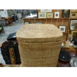 A CANE CUBOID LINEN BASKET WITH LIFT OFF COVER