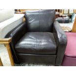 A BLACK LEATHER UPHOLSTERED ARMCHAIR