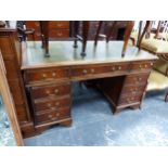 A MAHOGANY PEDESTAL DESK WITH NINE DRAWERS BELOW THE GREEN LEATHER INSET TOP