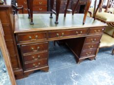 A MAHOGANY PEDESTAL DESK WITH NINE DRAWERS BELOW THE GREEN LEATHER INSET TOP