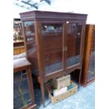 A MAHOGANY DISPLAY CABINET, THE GLAZED DOORS AND SIDES OVER GLASS SHELVES AND ABOVE TAPERING