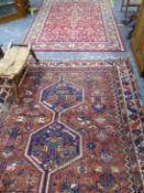 AN ANTIQUE HAND WOVEN RUG AND A LATER RUG