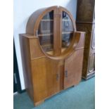 AN ART DECO OAK SIDE CABINET WITH A CIRCLE OF GLAZED DOORS OVER SHELVES ABOVE AND BETWEEN