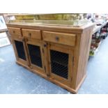 A PINE SIDEBOARD WITH THREE DRAWERS OVER IRON GRILLE PANELLED DOORS